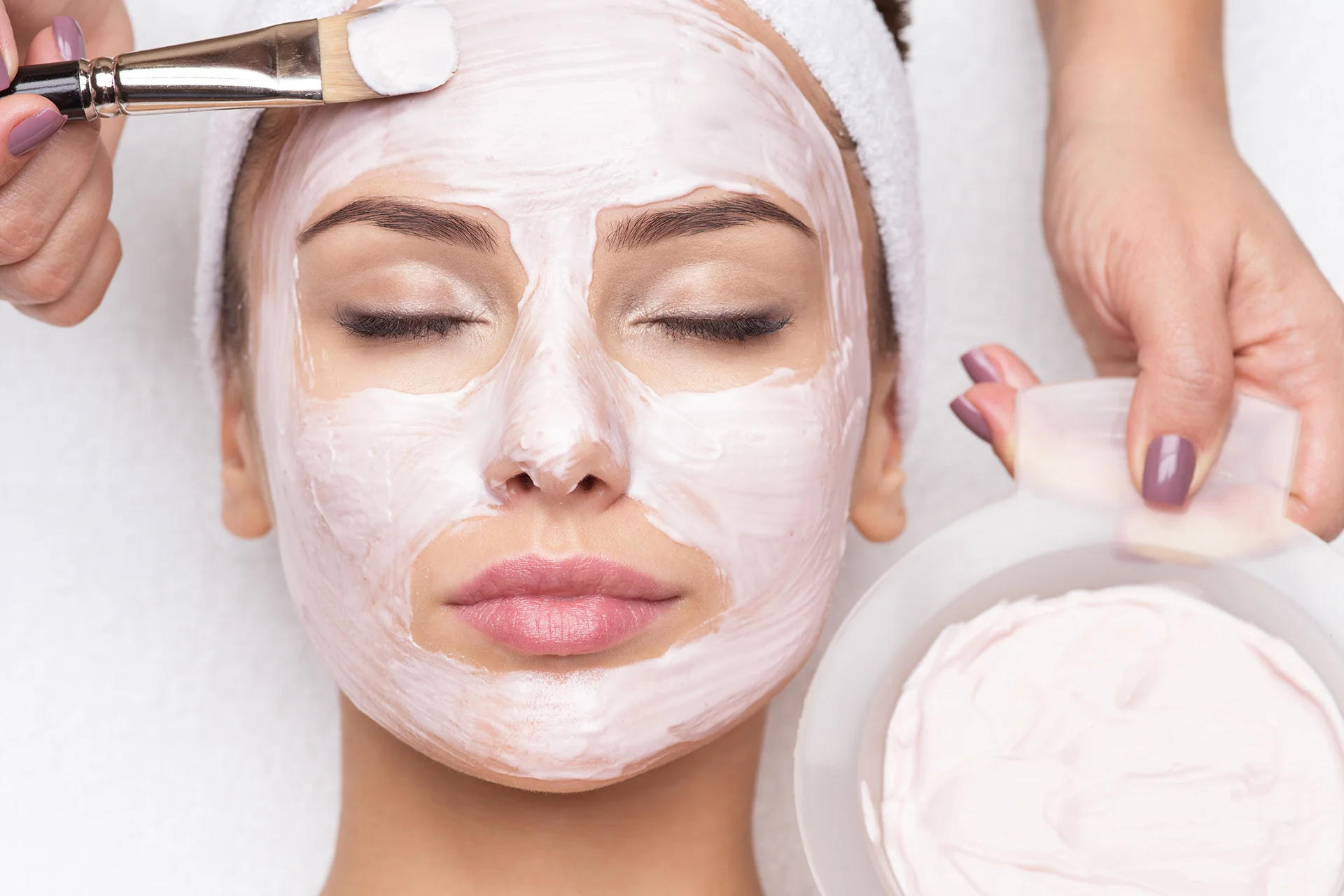 Woman receiving a facial mask spa treatment